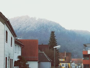 Houses against sky during winter