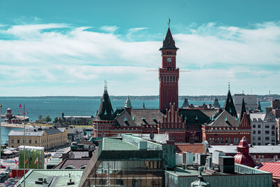 Clock tower amidst buildings in city