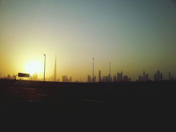 Silhouette of buildings against sky at sunset