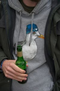 Close-up of man holding bottle