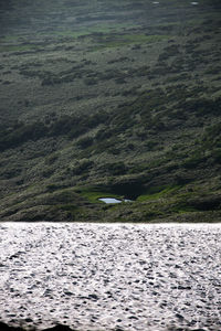 Scenic view of sea against mountain