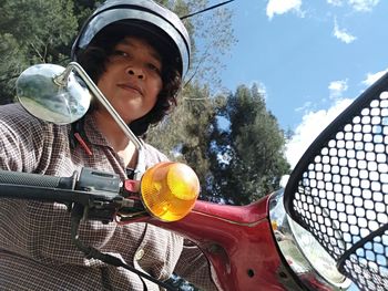 Portrait of a woman learning to ride old scooter