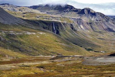 Scenic view of landscape and mountains against sky