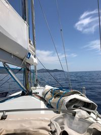 Sailboat sailing on sea against sky