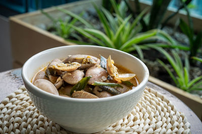 Chilli butter cream clam served in a bowl on a table.