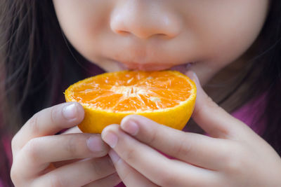 Close-up of baby holding fruit