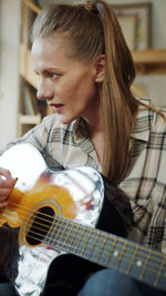 Close-up of girl playing guitar