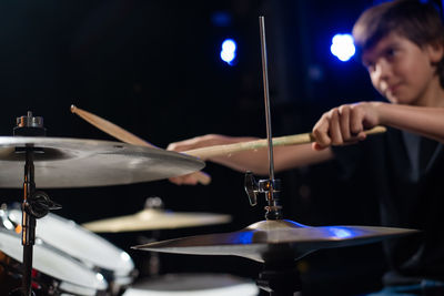 Cropped hand of man playing guitar