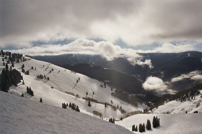 Scenic view of mountains against cloudy sky