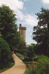 Mid distance view of arundel castle amidst trees against sky