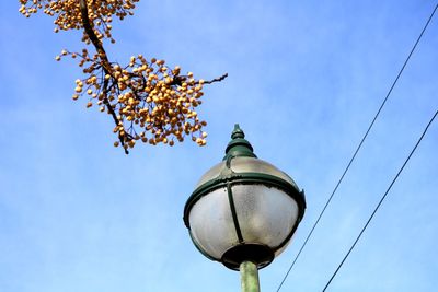 Low angle view of street light against blue sky