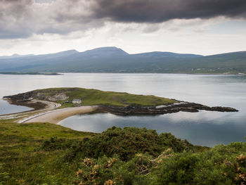 View of calm lake against cloudy sky