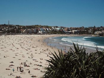 View of town at beach against blue sky