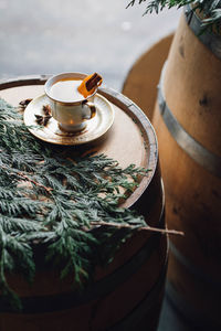 Winter holiday happy hour with hot toddy teacup on whiskey barrel