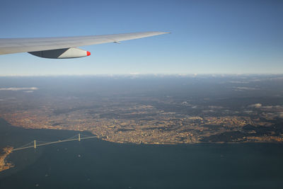 Aerial view of airplane flying in city