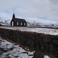 House by building against sky during winter