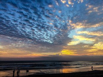 Scenic view of beach against sky during sunset