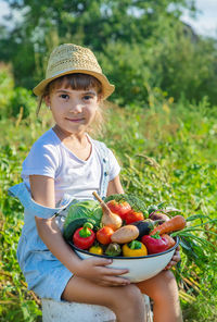 Portrait of boy holding fruit