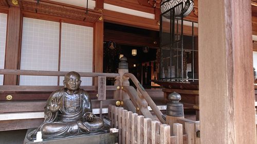 Statue against building
