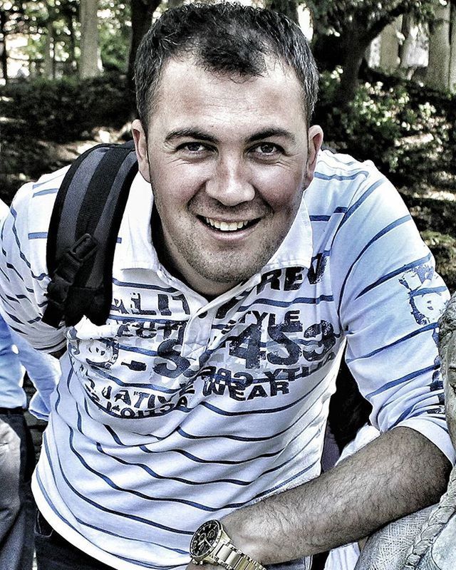 PORTRAIT OF SMILING YOUNG MAN WITH TATTOO