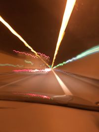 Close-up of light trails against sky at night