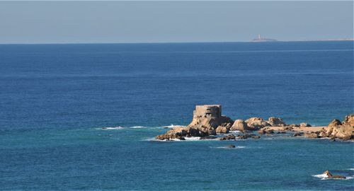 Scenic view of sea against blue sky