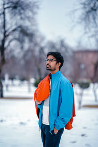 Young man standing on snow