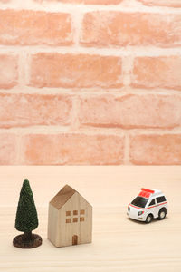 Toy car against brick wall