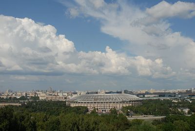 Buildings in city against cloudy sky