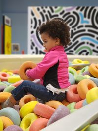 Side view of a baby girl with toy