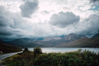 Scenic view of lake and mountains against sky