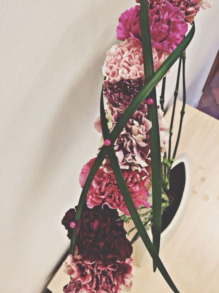 flower, freshness, indoors, red, growth, decoration, fragility, plant, pink color, close-up, table, vase, potted plant, nature, low angle view, no people, petal, leaf, day, bunch of flowers