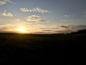 Scenic view of field against sky during sunset