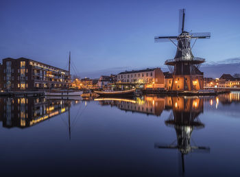 Reflection of illuminated buildings in city at night