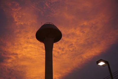 Low angle view of street light against orange sky