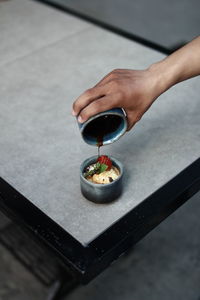 High angle view of person preparing food on table