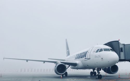 Airplane at runway during foggy weather