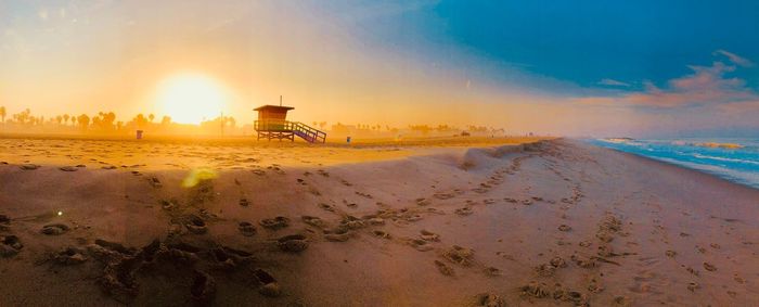 Scenic view of beach against sky during sunset