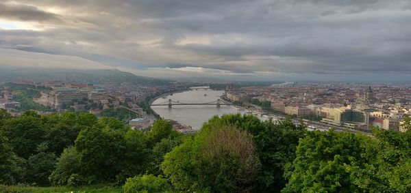 High angle view of river and buildings against sky