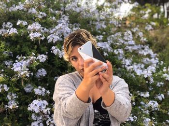 Portrait of young woman using mobile phone