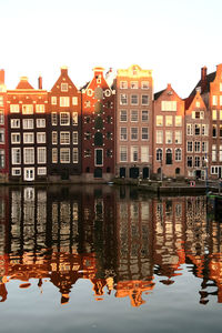 Reflection of buildings in lake against sky