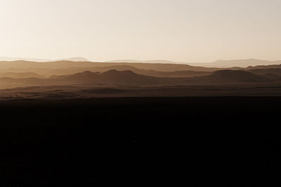 Scenic view of silhouette mountains against sky during sunset