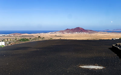 Scenic view of beach against blue sky