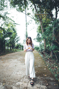 Smiling woman walking on footpath