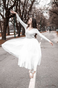 Ballerina dancing on road