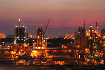 Illuminated buildings against sky at night