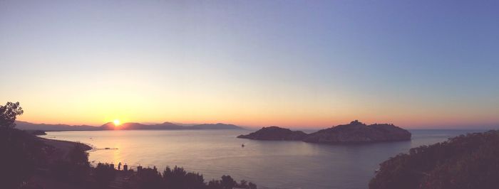 Scenic view of sea against clear sky during sunset