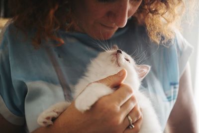 Close-up of woman holding cat