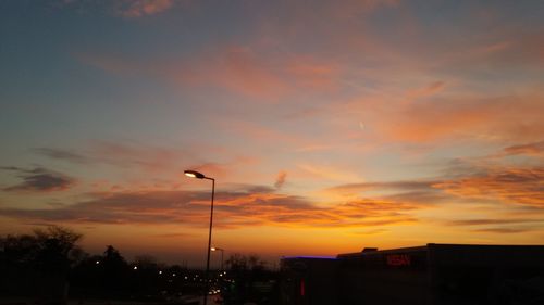 Low angle view of silhouette buildings against sky during sunset