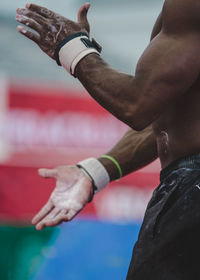 Midsection of male athlete with chalky hands
